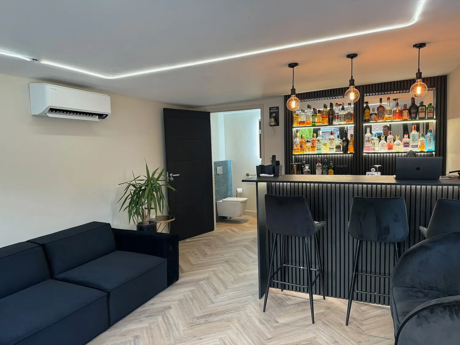 Wall-mounted Samsung air conditioning unit installed high on a garden-room wall